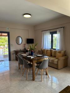 a living room with a table and a couch at Ada's House 2 in Mytikas