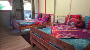 a room with three beds and a couch at Kay Lydie in Saint-Joseph