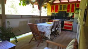 a kitchen with a table and chairs in a kitchen at Kay Lydie in Saint-Joseph