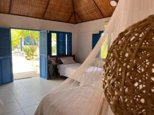 a bedroom with a bed with a mosquito net at Bayside Island in Cartagena de Indias +27 photos