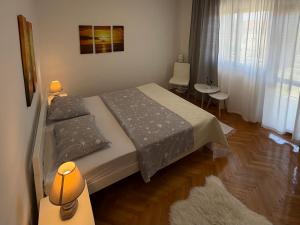 a bedroom with a bed with two pillows on it at MAG Apartmani in Jezera