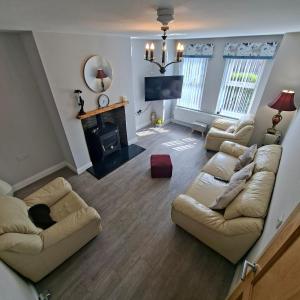 a living room with two couches and a fireplace at Semos in Strabane