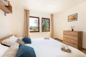 a bedroom with a large white bed and a window at Stella Maris in Ploče