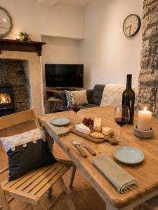 a living room with a wooden table with wine glasses at Steam Mill in Wellow +11 photos
