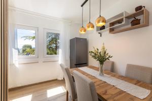 a dining room with a wooden table and chairs at Stella Maris in Ploče