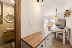 a bathroom with a sink and a table with a mirror at Stella Maris in Ploče +19 photos