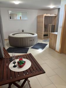 a bathroom with a tub and a table with a plate of food at Kuća za odmor Kiara in Kolarec +15 photos
