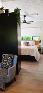 a bedroom with a bed and a chair and a window at Studio 149 - Wild Coast Accommodation in Sunrise-on-Sea +44 photos