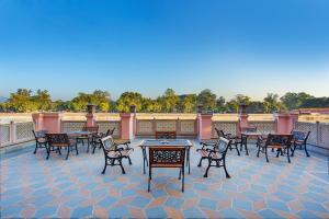 a group of tables and chairs on a patio at The Haveli Hari Ganga by Leisure Hotels in Haridwār