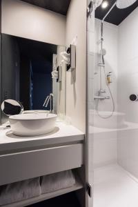 a bathroom with a sink and a shower at Hôtel Restaurant Ar Iniz in Saint Malo