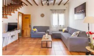 a living room with a couch and a table at Casa rural LA PEDANIA in El Salse