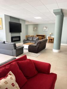 a living room with a red couch and a tv at Blue Water House in Bundoran