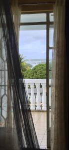 an open window with a view of a balcony at Studio Aiko2 côtière in Mauritius