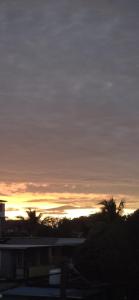 a sunset in the sky with palm trees at Studio Aiko2 côtière in Mauritius +1 photo