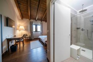 a bathroom with a shower and a bedroom with a bed at Bastianich Rooms in Gagliano +26 photos