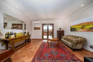 a living room with a couch and a table at Bastianich Rooms in Gagliano