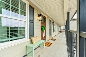 a porch of a house with a bench and a window at Roaring On Ross In Auburn in Auburn