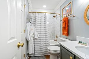 a white bathroom with a sink and a toilet at Roaring On Ross In Auburn in Auburn +7 photos