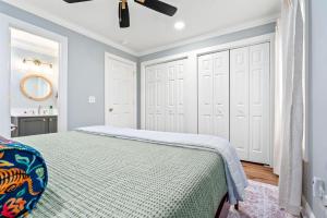 a bedroom with a bed and a ceiling fan at Roaring On Ross In Auburn in Auburn