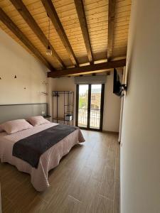 a bedroom with a large bed and a large window at Hotel Rural El Pingón in Manzanal de Arriba