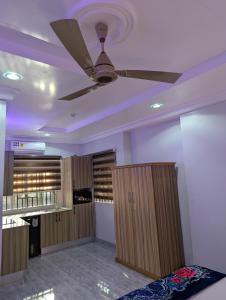 a room with wooden cabinets and a ceiling fan at WAB STAR Lodge in Kumasi