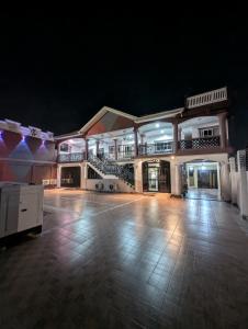a large building with a dance floor at night at WAB STAR Lodge in Kumasi