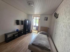 a bedroom with a bed and a television in a room at Ferienwohnung Gabry in Saarlouis