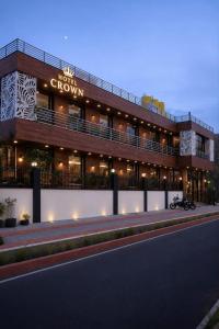 a building with a motorcycle parked in front of it at Hotel Empress Grand in Tājganj