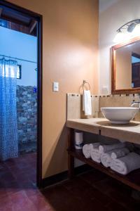 a bathroom with a sink and a mirror at Tides Oceanfront Resort in Santa Cruz +28 photos