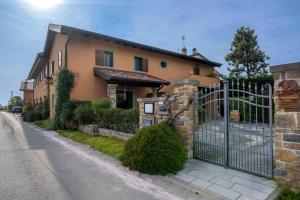 a house with a gate on the side of the road at Bastianich Rooms in Gagliano