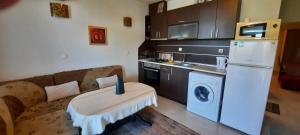 a kitchen with a couch and a washer and dryer at Cozopol Budjaka in Sozopol