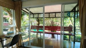a room with a bench in front of a window at Hill Zone Home Stay by Little Paradise in Haad Rin