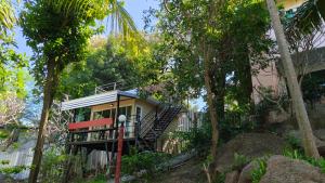 a house with a staircase in the middle of trees at Hill Zone Home Stay by Little Paradise in Haad Rin +36 photos