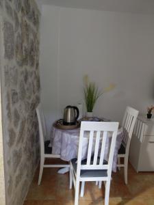 a table and chairs with a tea pot on it at Anastasija & Tara in Ðuraševići +13 photos