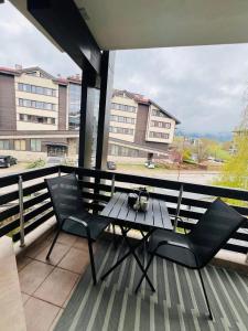 a table and chairs on a balcony with a view at Bansko Aspen Relax & Chill in Bansko