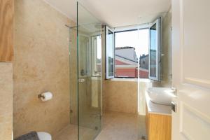 a bathroom with a glass shower and a sink at Pinia Penthouse by Corfuescapes in Corfu +26 photos