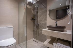 a bathroom with a toilet and a sink and a shower at Bazaar Inn Boutique & Luxury Rooms in Skopje +10 photos