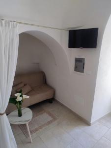 a living room with a couch and a table at Trullo MaPì in San Michele Salentino