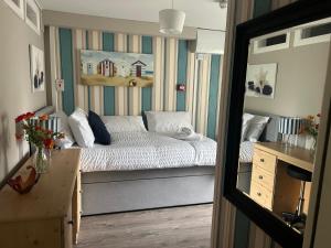 a small bedroom with a bed and a desk at 7 The Diamond in Ballycastle