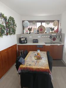 a kitchen with a table with a plate of food on it at Aliki's Foini House in Phini