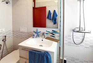 a bathroom with a sink and a shower at Appartamenti Alaska in Bibione