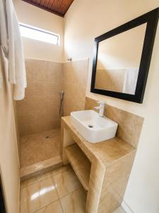 a bathroom with a sink and a mirror at Auberg'inn in Toliara
