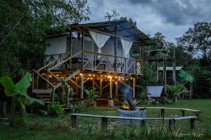 a house with a fire place in front of it at El Nido in La Macarena