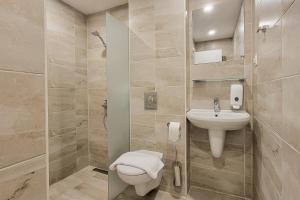 a bathroom with a toilet and a sink at Terminal Park in Bischofsheim +22 photos
