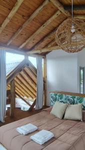 a large bed in a room with a wooden ceiling at Mirador in San Pedro