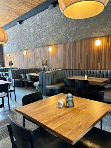 a restaurant with a wooden table and chairs and tables at Iconik Hotel in Medellín