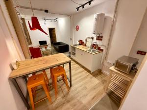 a small kitchen with a table and two chairs at The Orange Teddy Bear Gijón in Gijón
