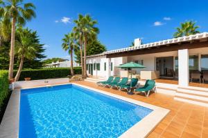 a swimming pool in the backyard of a house at Villa Binipaco in Binibeca