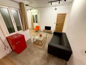 a living room with a couch and a table at The Orange Teddy Bear Gijón in Gijón