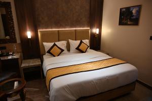 a bedroom with a large bed in a hotel room at Florys Residency in Ooty
